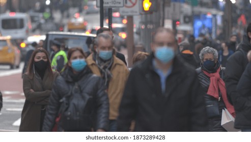 NEW YORK - CIRCA DECEMBER 2020: Crowd Of People Wearing Masks Walking Street 