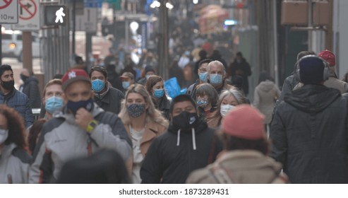 NEW YORK - CIRCA DECEMBER 2020: Crowd Of People Wearing Masks Walking Street 