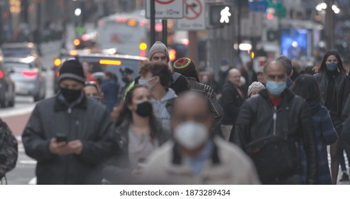 NEW YORK - CIRCA DECEMBER 2020: Crowd Of People Wearing Masks Walking Street 