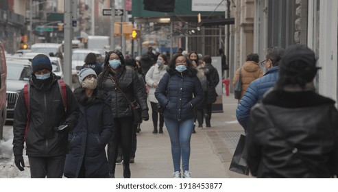 NEW YORK - CIRCA FEBRUARY 2021: Crowd Of People Walking Street Wearing Masks In SoHo During Covid 19 Pandemic