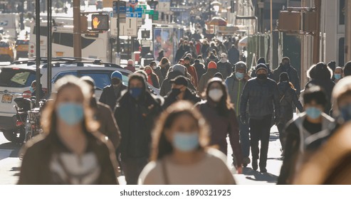 NEW YORK - CIRCA JANUARY 2021: Crowd of people walking street wearing masks