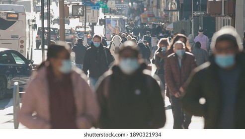 NEW YORK - CIRCA JANUARY 2021: Crowd Of People Walking Street Wearing Masks
