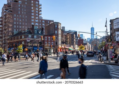 NEW YORK CITY - 2020: Busy crowds of people walking across a congested intersection on 7th Avenue in the West Village neighborhood of Manhattan