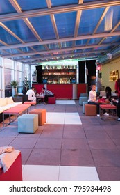 New York City - 24 May 2017: Interior Of The Cantina Rooftop Bar In Midtown West Manhattan.  People Sitting On Plush Stools Around Tables Under A Glass Covering On The Rooftop Of Cantina Bar, NYC.