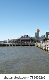 New York City - 3 June 2017: View Of People Drinking At A Hip New York City Rooftop Bar In Lower Manhattan, City Vineyard, On Pier 26, View Of The Hudson River On A Summer Day, Blue Sky No Clouds.