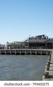 New York City - 3 June 2017: People Having A Drink On The New York City Rooftop Bar City Vineyard On Pier 26 In Lower Manhattan On A Sunny Day With Blue Sky And No Clouds.