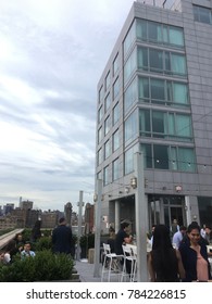 New York City - 6 June 2017: People enjoying a rooftop drink at Mr Purple, the rooftop bar on the 15th floor of the Hotel Indigo in Manhattan's Lower East Side. After work crowd having a drink on roof
