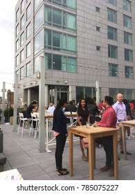 New York City - 6 June 2017: People Standing Enjoying A Drink On Hotel Indigo's Rooftop Bar, Mr Purple, On The 15th Floor In Manhattan's Lower East Side. After Work Crowd On A Rooftop Bar In NYC.