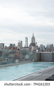 New York City - 8 June 2017: Lap pool on the rooftop of Hotel Indigo on Orchard Street in Lower Manhattan. View of the Empire State Building and New York City Skyline from luxury hotel rooftop in NY.