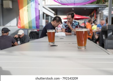 New York City - 9 September 2017: Men drinking on the gay friendly rooftop bar Boxers Sports Bar in Hell's Kitchen Manhattan, New York City. Rooftop bar in New York on a sunny weekend.