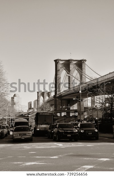 NEW YORK CITY - APR 1: Downtown Manhattan street\
view with Brooklyn Bridge on April 1, 2015 in Manhattan, New York\
City. With population of 8.4M, it is the most populous city in the\
United States.