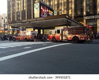 New York City - April 1, 2016: FDNY fire engine and ambulance sit outside Penn Station responding to an emergency.