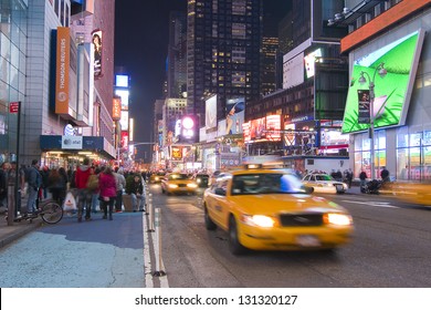 NEW YORK CITY - APRIL 19: Times Square is a busy tourist intersection of neon art and commerce and is an iconic place of New York City and USA, on April 19, 2011 in Manhattan, New York City. - Shutterstock ID 131320127