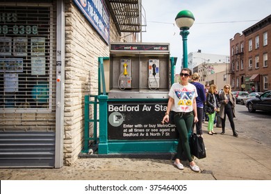 NEW YORK CITY - APRIL 28, 2013: Street corner scene from Williamsburg Brooklyn, New York City with Bedford Avenue subway entrance seen.