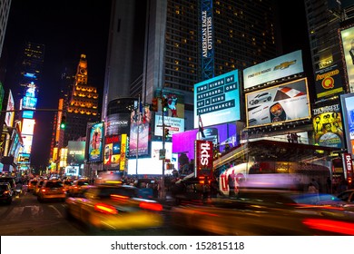 NEW YORK CITY - AUGUST 12: Times Square, Is A Busy Tourist Intersection Of Neon Art And Commerce  Of New York City And USA At Night On August 12, 2013 In Manhattan, New York , NY