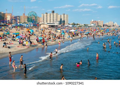 NEW YORK CITY - AUGUST 20, 2017: Crowds of people flock to the Coney Island beach and boardwalk on a hot summer weekend.