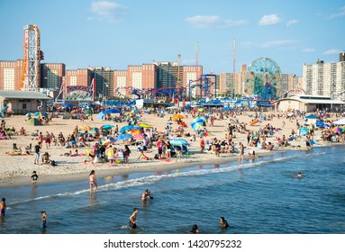 NEW YORK CITY - AUGUST 20, 2017: Crowds Of People Flock To The Coney Island Beach And Boardwalk On A Hot Summer Weekend.