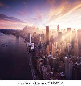 New York City - beautiful colorful sunset over manhattan fit sunbeams between buildings