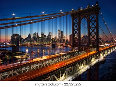 New York City - beautiful sunset over manhattan with manhattan and brooklyn bridge