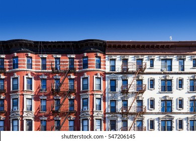 New York City block of old historic apartment buildings in the East Village of Manhattan, NYC with a clear blue sky background