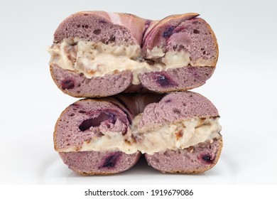 New York City Blueberry Bagel Cut In Half With Strawberry Cream Cheese	