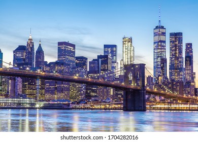 New York City And The Brooklyn Bridge At Sunset Along The East River