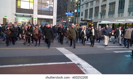 New York City - Circa 2017: Crosswalk Sign Change Stop Hand To Walk Signal, Mob Crowd Of Busy Commuting People Rush Across Manhattan Street Traffic Intersection To Penn Station Traveling Home On LIRR.