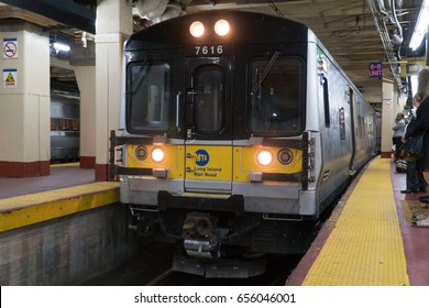 New York City, Circa 2017: LIRR Long Island Railroad train arrive Penn Station NY. Rush hour commute passengers wait on platform to board and travel home.
