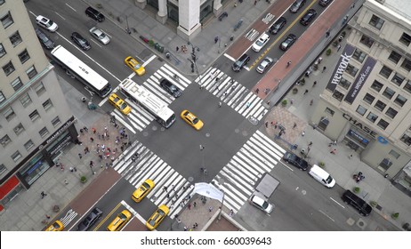 New York City, Circa 2017: Overhead Aerial Birds Eye View Overhead Busy Manhattan Intersection Day Time. People, Bus, Yellow Taxi Traffic Travel Downtown Avenue.