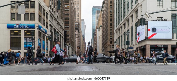 New York City, Circa 2017: Manhattan crosswalk intersection low angle panorama view. Outside Macys herald square Citibank day time exterior photo. People safety crossing street