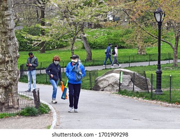 NEW YORK CITY CIRCA APRIL 2020. As the COVID-19 coronavirus pandemic broadens in scope, more people wear face masks such as in Central Park to protect against the virus
