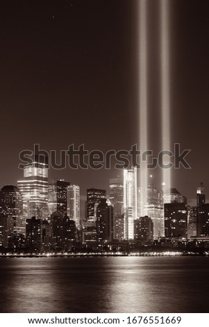 New York City downtown urban architecture at night and September 11 tribute light