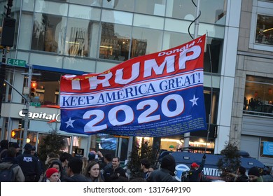 New York City, February 19, 2019 - Counter Protester At An Rally Against President Trump's National Emergency Waving A Large 