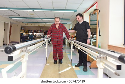 NEW YORK CITY - FEBRUARY 8 2017: Menorah Center Provides State Of The Art Rehabilitation & Long Term Care In Its Manhattan Beach Location. Therapist Guides Patient In Gait Therapy Using Parallel Bars