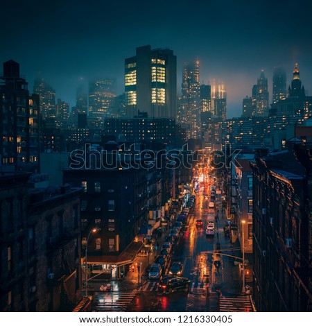 New York City in foggy raining weather at night. Streets of Chinatown at the storm.