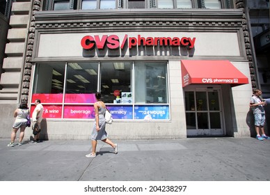 NEW YORK CITY - FRIDAY, JUNE 20, 2014: Shoppers walk past a CVS drug store in New York City on Wednesday, July 2, 2014.  CVS is the retail division of CVS Caremark