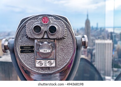 NEW YORK CITY - JULY 16, 2016: Beautiful view of downtown Manhattan from the Rockefeller Center. Binoculars with Empire State Building in the background.
