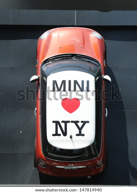 NEW YORK\
CITY - July 18: Mini Cooper dealership in Manhattan on July 18,\
2013.  In 1999 the Mini was voted the second most influential car\
of the 20th century, behind the Ford Model\
T