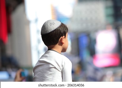 NEW YORK CITY - JULY 20 2014: several thousand supporters of Israeli actions in Gaza staged a rally in Times Square. Yarmulka wearing boy with Times Square background