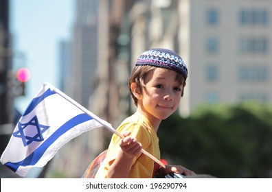NEW YORK CITY - JUNE 1 2014: The 50th annual Israel Day Parade filled Fifth Avenue with politicians, revelers & a few protestors marking Israel's 66th anniversary. Little boy with cap & Israeli flag