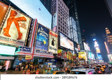  NEW YORK CITY - JUNE 12, 2015: Times Square at night featuring lighted billboards of the broadway best show