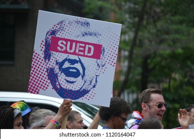 New York City, June 24, 2018 - People carrying signs while marching in the New York City Pride Parade.