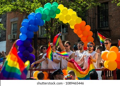 NEW YORK CITY - JUNE 25, 2017: Participants Wave Rainbow Flags On A Float With A Balloon Arch In The Annual Pride Parade As It Passes Through Greenwich Village.