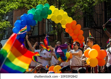 NEW YORK CITY - JUNE 25, 2017: Participants Wave Rainbow Flags On A Float With A Balloon Arch In The Annual Gay Pride Parade As It Passes Through Greenwich Village.