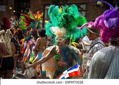 NEW YORK CITY - JUNE 25, 2017: Participant dressed in flamboyant carnival costume participates in annual Pride Parade as it passes through Greenwich Village.