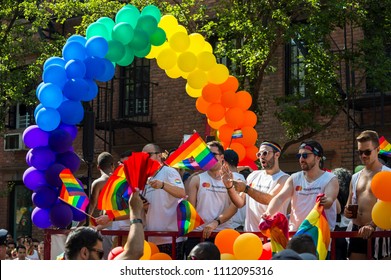 NEW YORK CITY - JUNE 25, 2017: Participants Wave Rainbow Flags On A Float With A Balloon Arch In The Annual Pride Parade As It Passes Through Greenwich Village.