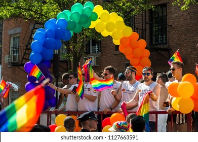 NEW YORK CITY - JUNE 25, 2017: Participants Wave Rainbow Flags On A Float With A Balloon Arch In The Annual Pride Parade As It Passes Through Greenwich Village.