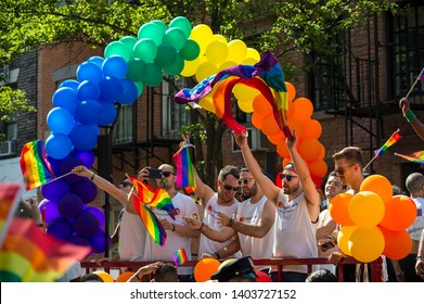 NEW YORK CITY - JUNE 25, 2017: Participants Wave Rainbow Flags On A Float With A Balloon Arch In The Annual Pride Parade As It Passes Through Greenwich Village.