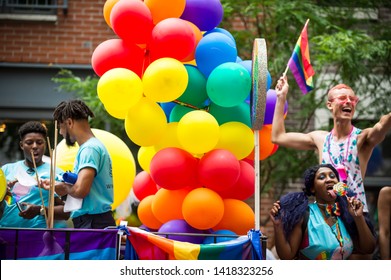 NEW YORK CITY - JUNE 25, 2017: Participants Wave Rainbow Flags On A Float With A Balloon Arch In The Annual Gay Pride Parade As It Passes Through Greenwich Village.