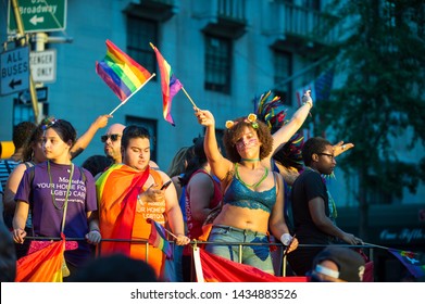 NEW YORK CITY - JUNE 25, 2017: Participants Wearing Shirts Sponsored By Montefiore Medical Center Wave Flags On A Float In The Gay Pride Parade In Greenwich Village.